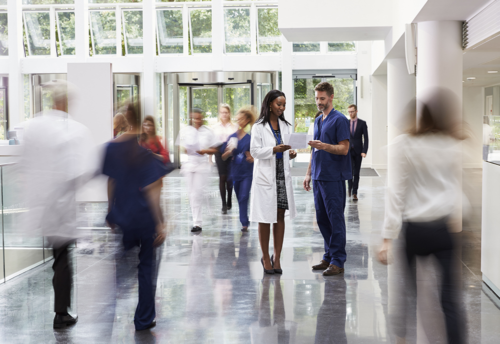 doctors and nurses quickly walking through a hospital corridor